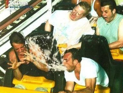 Man vomits over people on a roller coaster. Eww.